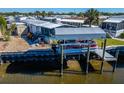 Covered boat lift and floating dock on the water at 110 W Saint Annes Cir, Apollo Beach, FL 33572