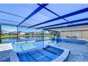 Relaxing pool and spa with covered patio overlooking lake at 11807 Cross Vine Dr, Riverview, FL 33579