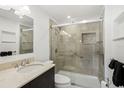 Modern bathroom featuring a tiled walk-in shower with glass door, updated vanity, and accessible features at 1847 Shore S Dr # 509, South Pasadena, FL 33707