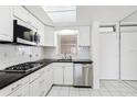 Bright condo kitchen with stainless steel appliances and white cabinets at 1847 Shore S Dr # 509, South Pasadena, FL 33707