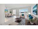 Bright living space with neutral décor, tile floors, and large windows showcasing picturesque water views at 1847 Shore S Dr # 509, South Pasadena, FL 33707