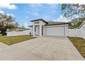 Newly built home with white exterior, driveway, and grassy front yard at 200 W Kirby St, Tampa, FL 33604