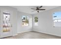 Bright and airy living room with hardwood floors, large windows, and ceiling fan at 200 W Kirby St, Tampa, FL 33604
