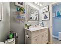 Bathroom with white vanity and nautical decor at 206 Hidden Harbour Dr, Indian Rocks Beach, FL 33785