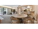 Round dining table with four chairs, view of kitchen at 36750 Us Highway 19 N # 19219, Palm Harbor, FL 34684