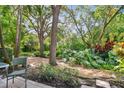 Peaceful backyard oasis with mature trees and lush tropical plants at 4616 Mirabella Ct, St Pete Beach, FL 33706