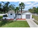 Property showcases a newly renovated home with a spacious yard and driveway at 6000 Francis Drive, Apollo Beach, FL 33572