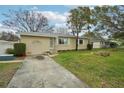 Front view of a house with a driveway and landscaping at 7201 Park S St, St Petersburg, FL 33707