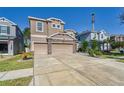 Two-story house with a two-car garage and landscaped yard at 10439 Waterstone Dr, Riverview, FL 33578