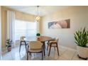 Bright dining area with round table and four chairs, well lit at 12303 Foxmoor Peak Dr, Riverview, FL 33579