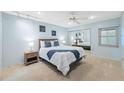 Comfortable bedroom with a mirrored closet, ceiling fan, and soft blue walls at 2367 Maben Cir # P9, Palm Harbor, FL 34683