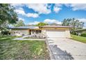 Charming single-story home with attached garage, well-maintained lawn, and beautiful curb appeal at 2640 Westchester N Dr, Clearwater, FL 33761