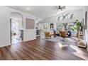 Bright living room boasts vaulted ceilings, hardwood floors and a large window with natural lighting at 35608 Welby Ct, Zephyrhills, FL 33541