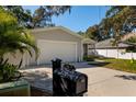 House exterior, driveway, and mailbox at 703 Old Charleston Way, Largo, FL 33770