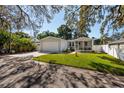 House exterior view, driveway, and street at 703 Old Charleston Way, Largo, FL 33770