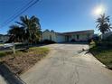 Ranch-style home with a large driveway at 11300 8Th E St, Treasure Island, FL 33706