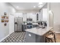 Stylish kitchen features stainless steel appliances, granite countertops, and patterned flooring at 12306 Woodlands Cir, Dade City, FL 33525