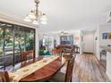 Bright dining area flows into the living room, featuring wood floors and a large window at 1901 Lennox E Rd # 1901, Palm Harbor, FL 34683