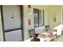 Private condo entrance with seating area and fire extinguisher at 20853 Haulover Cv # A8, Lutz, FL 33558