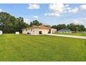 Tan house with a brown roof and attached garage at 3116 Gulfwind Dr, Land O Lakes, FL 34639