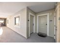 Condo hallway with doors to unit and window with water views at 399 2Nd St # 718, Indian Rocks Beach, FL 33785