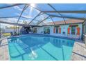 Inviting pool area with covered patio and seating at 4294 Paradise Cir, Hernando Beach, FL 34607