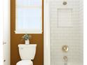 Small bathroom with white subway tile, a shower/tub combo, and an accent wall at 1109 Seagrape Dr, Ruskin, FL 33570