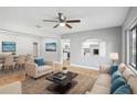 Open living area with wood floors, neutral color scheme, and pass-through to the kitchen at 12006 Bethwood Ave, New Port Richey, FL 34654