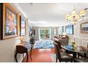 Bright living room with hardwood floors, featuring a dining area and balcony access at 147 Bluff View Dr # 204, Belleair Bluffs, FL 33770