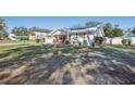 House exterior showcasing a spacious front yard and solar panels at 38919 3Rd Ave, Zephyrhills, FL 33542