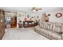 Spacious living room with two sofas and a view into the dining area at 38919 3Rd Ave, Zephyrhills, FL 33542