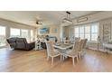 Elegant dining area featuring a large window, stylish lighting fixture, and beautiful hardwood floors at 501 Haben Blvd # 806, Palmetto, FL 34221