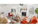 Cozy living room with a fireplace, wood floors, and comfortable seating, flooded with natural light at 523 Deville E Dr, Largo, FL 33771