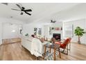 Bright living room with light-toned wood floors, fireplace, and comfortable seating, illuminated by natural light at 523 Deville E Dr, Largo, FL 33771