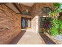 Double door entry with brick facade and tile flooring at 937 Bunker View Dr, Apollo Beach, FL 33572