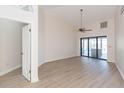 Bright living room with hardwood floors and sliding doors to pool area at 937 Bunker View Dr, Apollo Beach, FL 33572