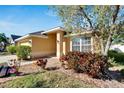 House exterior showcasing a two-car garage and mature landscaping at 10739 Standing Stone Dr, Wimauma, FL 33598