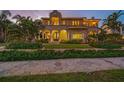 Stunning two-story home with manicured landscaping, stone walkway, and arched entry at 1925 Beach Se Dr, St Petersburg, FL 33705