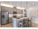 Modern kitchen with gray cabinets, island, and stainless steel appliances at 31457 Woodland Race Loop, Wesley Chapel, FL 33545