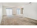 Spacious living room with carpeted floor and sliding glass doors at 3263 38Th S St # B, St Petersburg, FL 33711