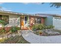 Welcoming front entry with brick facade and landscaped walkway at 3407 King George Ln, Seffner, FL 33584