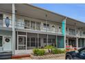 Two-story condo building with blue accents and well-kept landscaping at 4152 55 N Way # 1030, Kenneth City, FL 33709