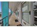 Exterior hallway of condo building with blue pillars, black railings, and unit doors at 4152 55 N Way # 1030, Kenneth City, FL 33709