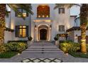 Stunning entryway with steps, lighting, and lush landscaping at 5120 W Longfellow Ave, Tampa, FL 33629