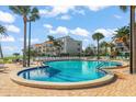 Inviting community pool with surrounding lounge chairs at 851 Bayway Blvd # 201, Clearwater, FL 33767