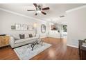 Spacious living room with hardwood floors, comfortable seating, and a view to the kitchen at 10334 Estero Bay Ln, Tampa, FL 33625