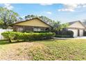 Landscaped front yard with three-car garage at 1121 Belladonna Dr, Brandon, FL 33510