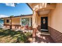 Welcoming front entry with brick walkway and landscaping at 1201 Kapok Cir, Clearwater, FL 33759