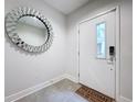 Bright entryway with tiled floors, large mirror, and modern door at 2511 N Grady N Ave # 59, Tampa, FL 33607