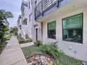 Townhouse exterior with walkway, landscaping, and private entrance at 2511 N Grady N Ave # 59, Tampa, FL 33607